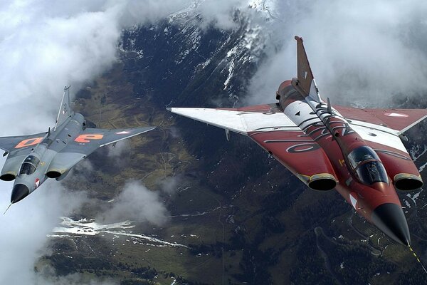 Kampfflugzeuge fliegen in der Luft über die Berge