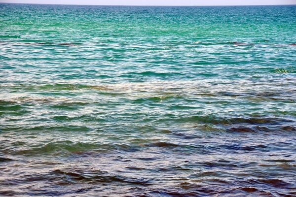 The water surface of the sea in turquoise-blue colors