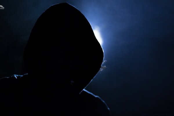 The night shadow of a hooded man