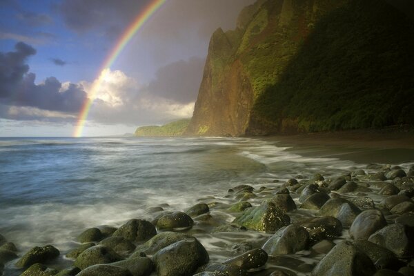 Rainbow on the shore of rocks