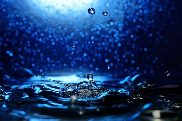 Water splashing on a shiny dark background