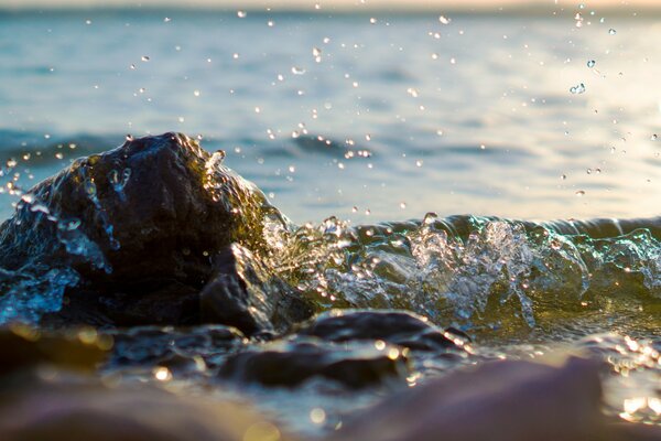 The sea in a calm state beats against the rocks on the shore