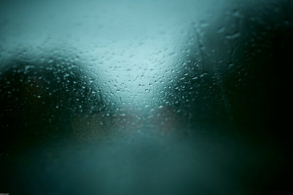 Photo of fogged blurred glass in the rain