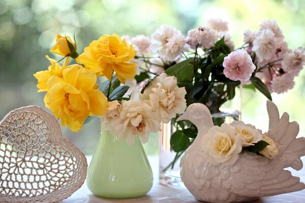 Pigeon and flowers in vases on the table