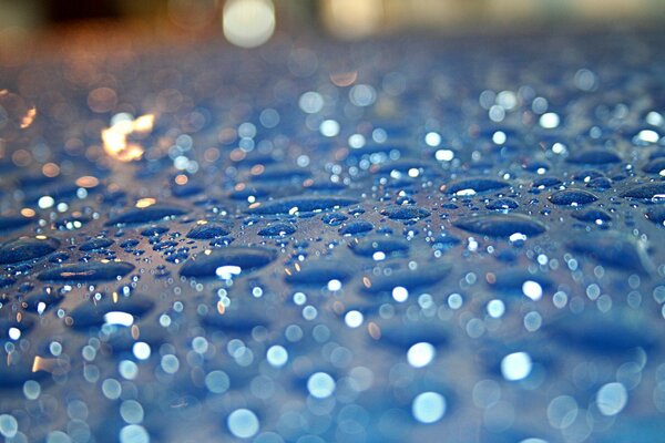 Water droplets on a blue surface