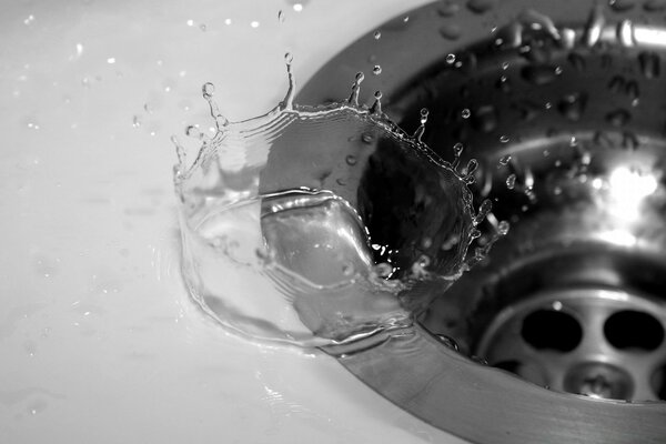 Drops of water drain into the sink