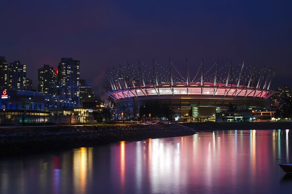 The night city is reflected in the water