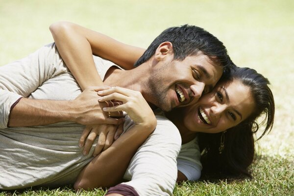 A couple in love is resting on the grass