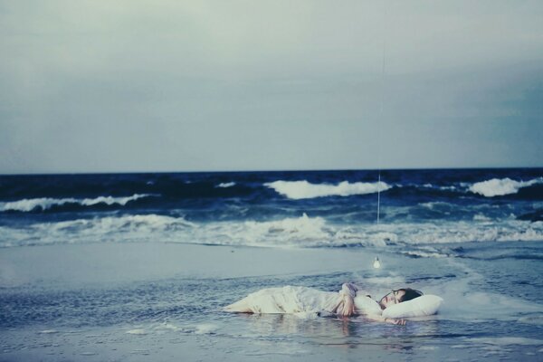 The girl sleeps near the sea