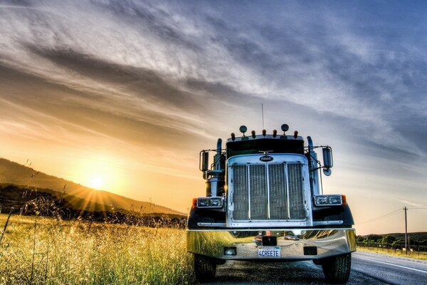 Truck on the road under the dawn sky