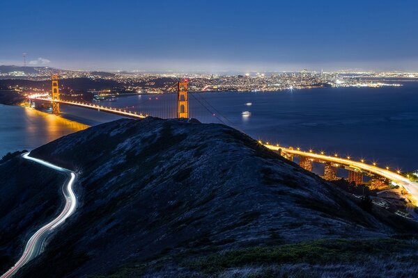 Night city. Bridge by the water