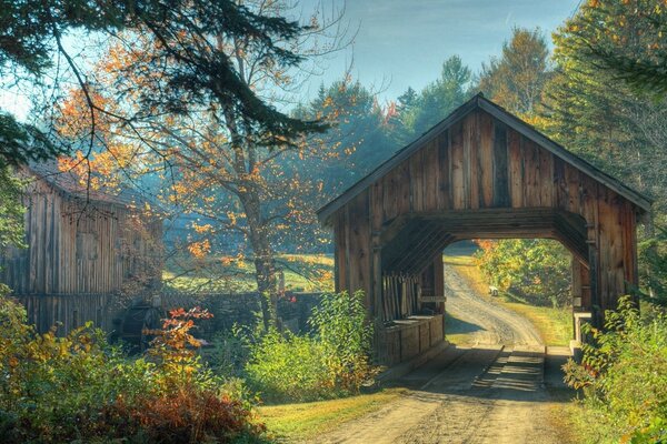 Village road passing through a wooden barn