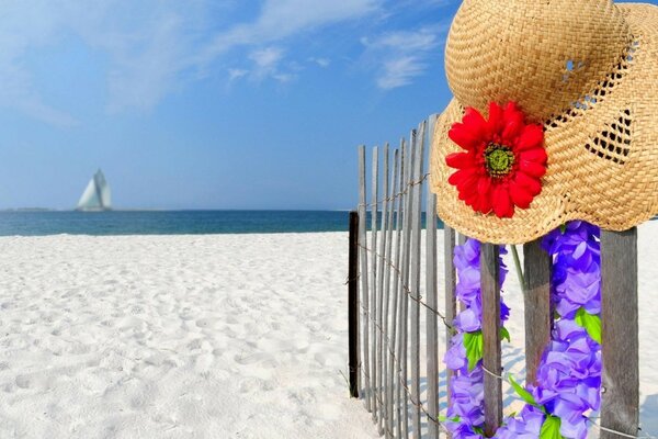 Straw hat on a snow-white beach