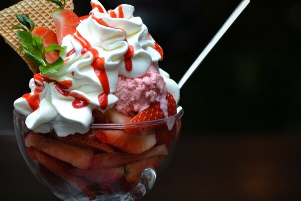 Strawberries, ice cream, whipped cream, waffle and parsley