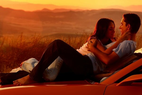 A couple in love at sunset in the mountains