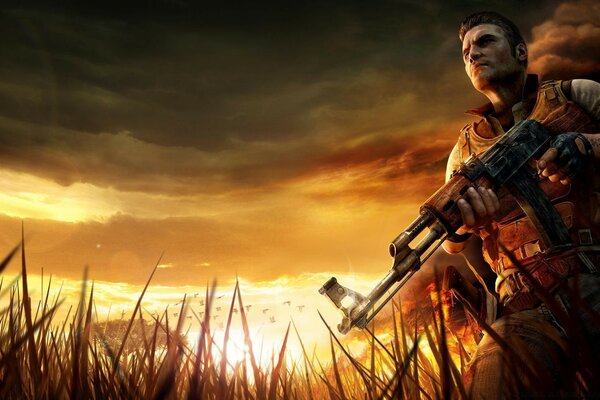 A man with a gun at sunset in the grass