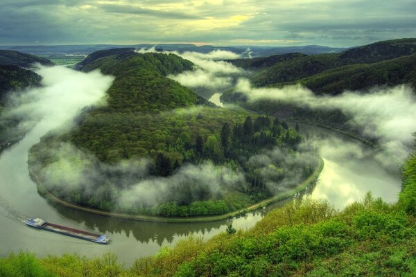 A barge floating on a winding river