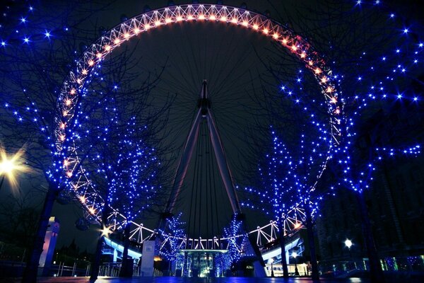 Ferris wheel with backlight on the background of the night sky