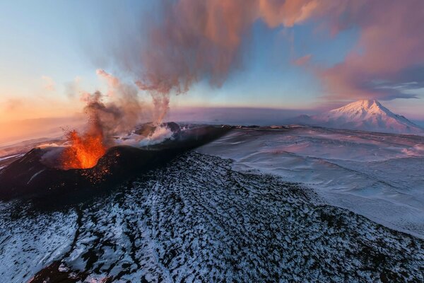 Volcanic eruption in the snow-capped mountains