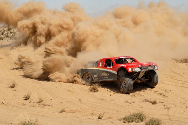 Car racing in the desert by car on the sand