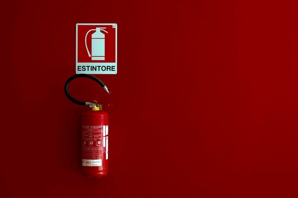 Fire extinguisher on a red background