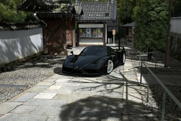 Black racing car on the sidewalk