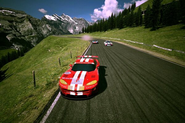 Voiture de sport de couleur rouge sur la route dans les montagnes