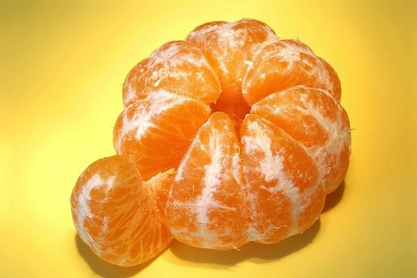 Peeled tangerine with a separate slice