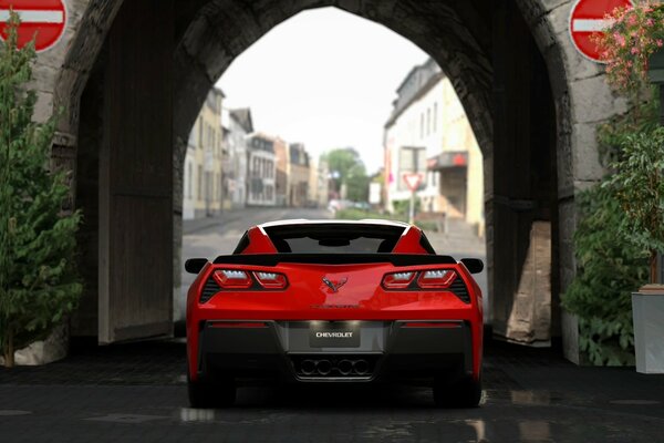 The red car is standing in the arch