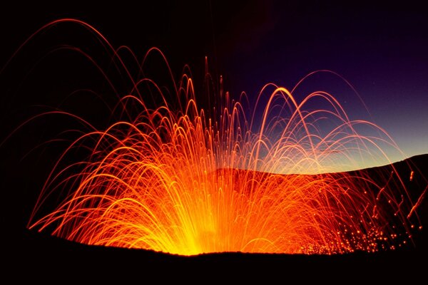 Volcanic eruption by lava at night