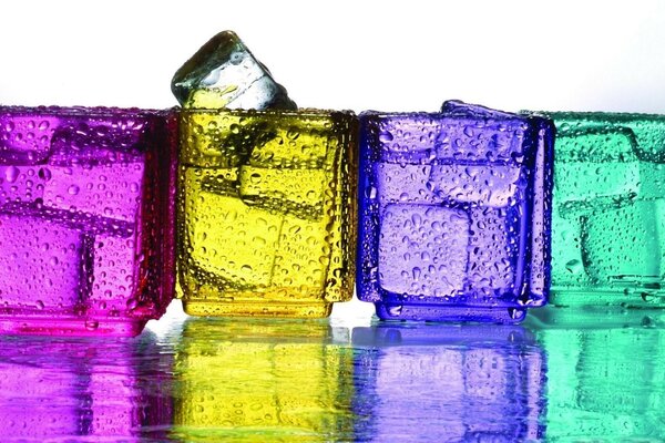 Ice cubes in brightly colored glasses