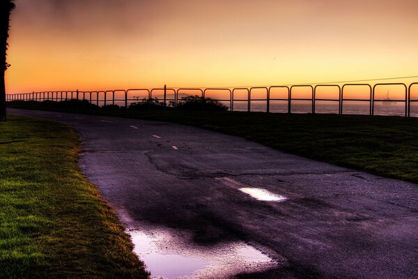 Evening summer road near the water