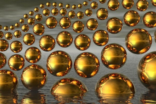 Eine große Anzahl von goldenen Kugeln, die teilweise ins Wasser eintauchen