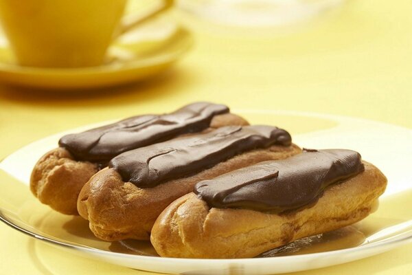 Three brownies with chocolate are on a plate