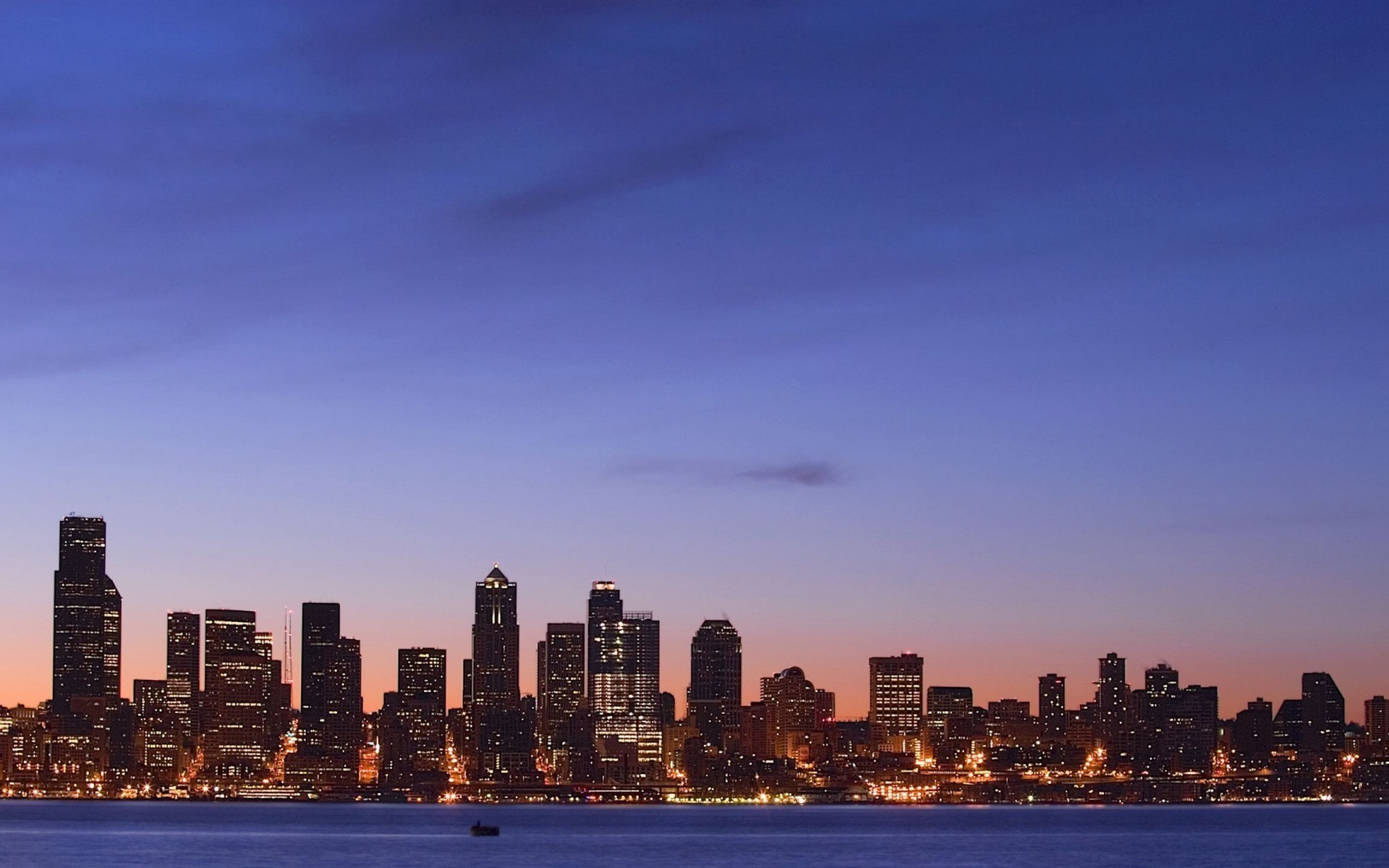 cidades centro da cidade arquitetura skyline arranha-céu cidade viagens anoitecer céu pôr do sol casa à noite água escritório o negó cio alta finança urbano beira-mar