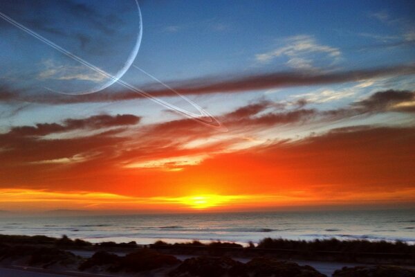 Pôr do sol à beira-mar com vista para Saturno