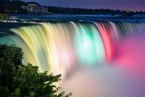 Illuminated waterfall near the city