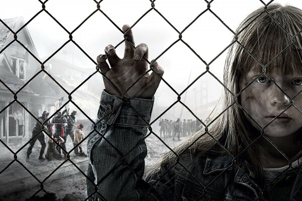 The girl behind the fence against the background of the war