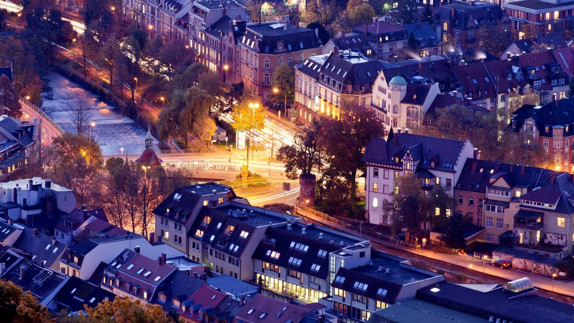 city travel evening architecture building dusk road cityscape illuminated light street urban transportation system town outdoors traffic car downtown skyline