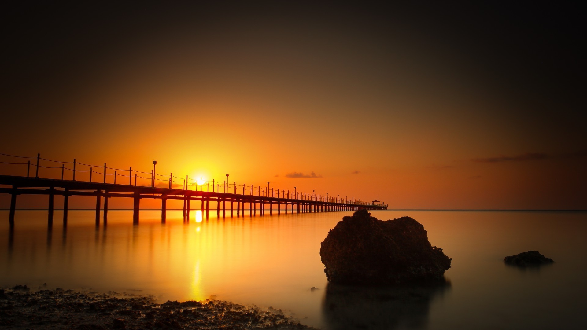 the sunset and sunrise sunset dawn water sea beach sun ocean evening dusk reflection bridge landscape sky pier silhouette light seascape lake