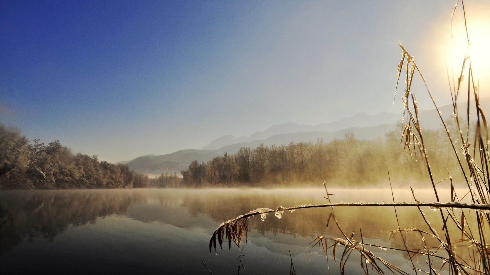 the sunset and sunrise dawn sunset fog winter water mist snow nature sun outdoors landscape sky lake fair weather evening dusk