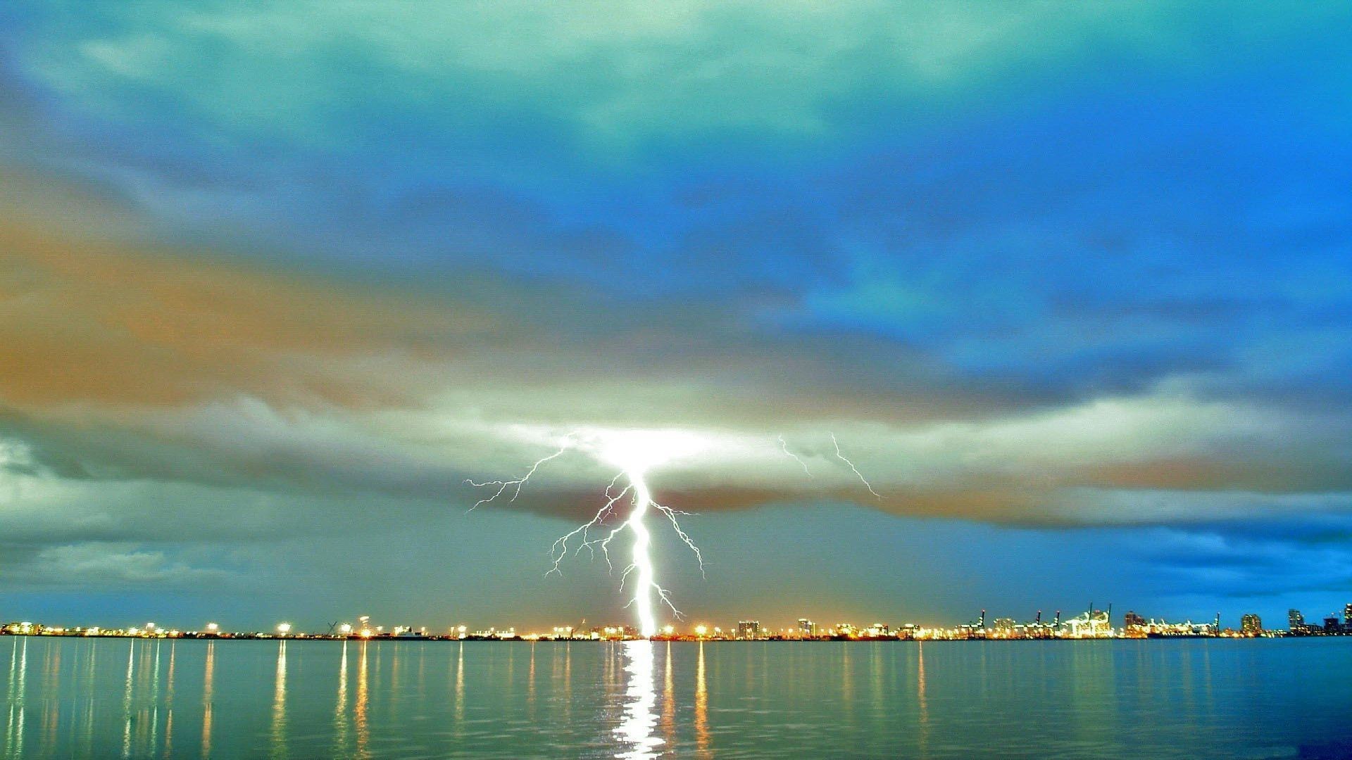 lightning water sky sunset sun sea ocean nature dawn beach landscape summer travel cloud storm boat reflection seascape fair weather