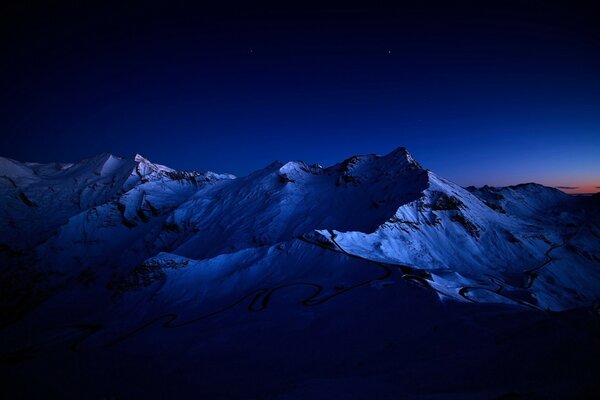 Landscape of snowy mountains in semi-darkness