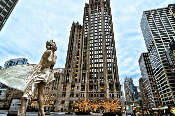 Monument to Marilyn Monroe on the background of skyscrapers