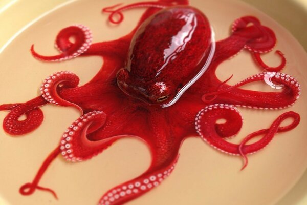 Installation of a pastry chef, an iron octopus floating in a plate