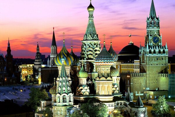 St. Basil s Cathedral with illumination on the background of a red sunset