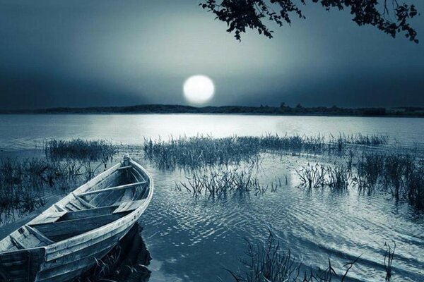 Boat on the lake in the evening twilight