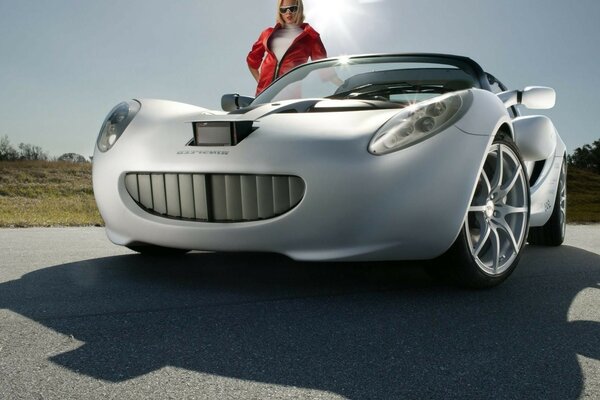 Photo of a woman on the background of a stylish sports car