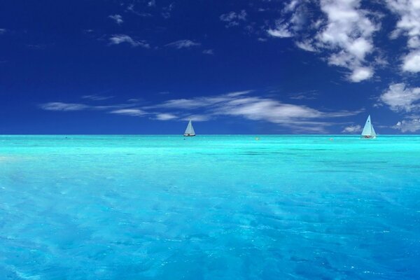 Transparent ocean surface and sailboats