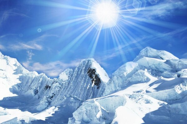 The rays of the sun illuminate the cold snowy peaks